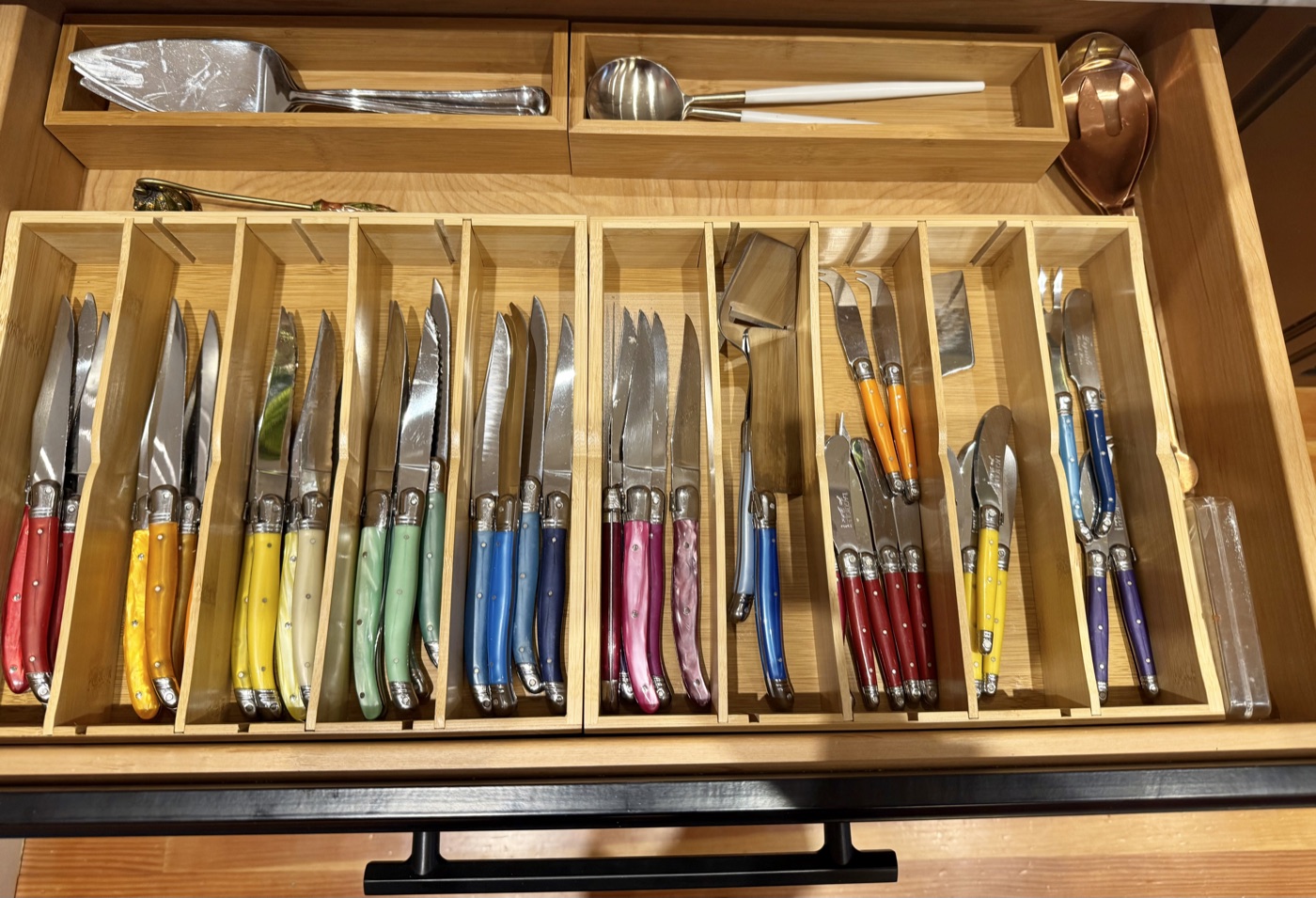 Kitchen drawer with colorful Laguiole knife collection