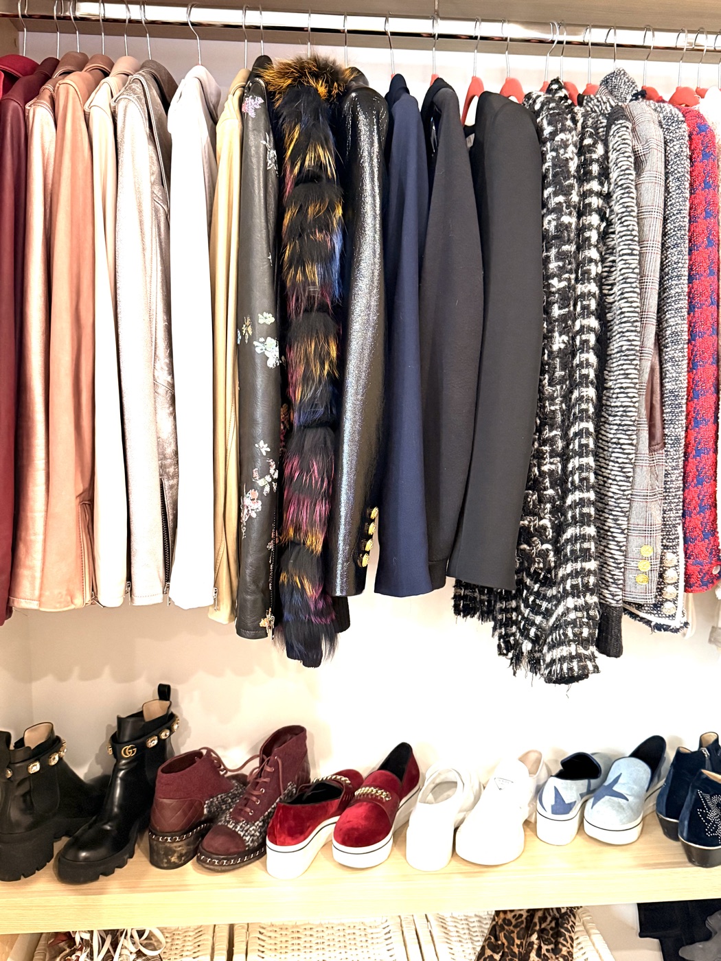 Designer outerwear and jackets with organized shoe display below