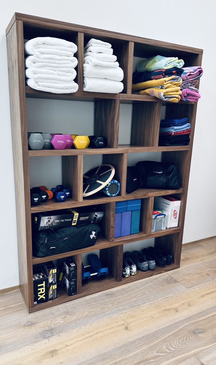 Home gym storage unit with weights, TRX, and workout equipment